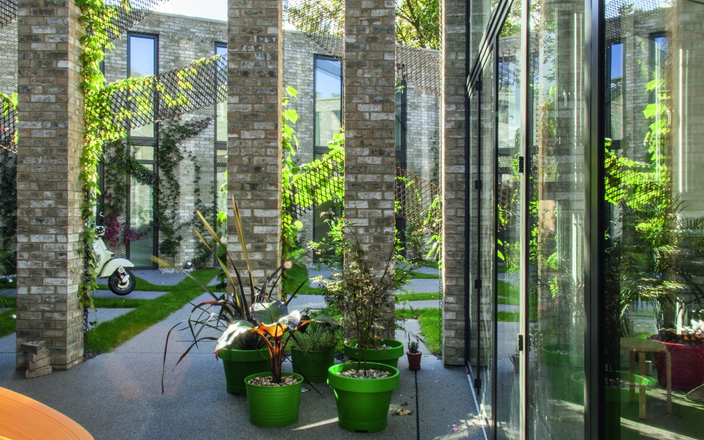 Brick columns and creeping green foliage in modern house