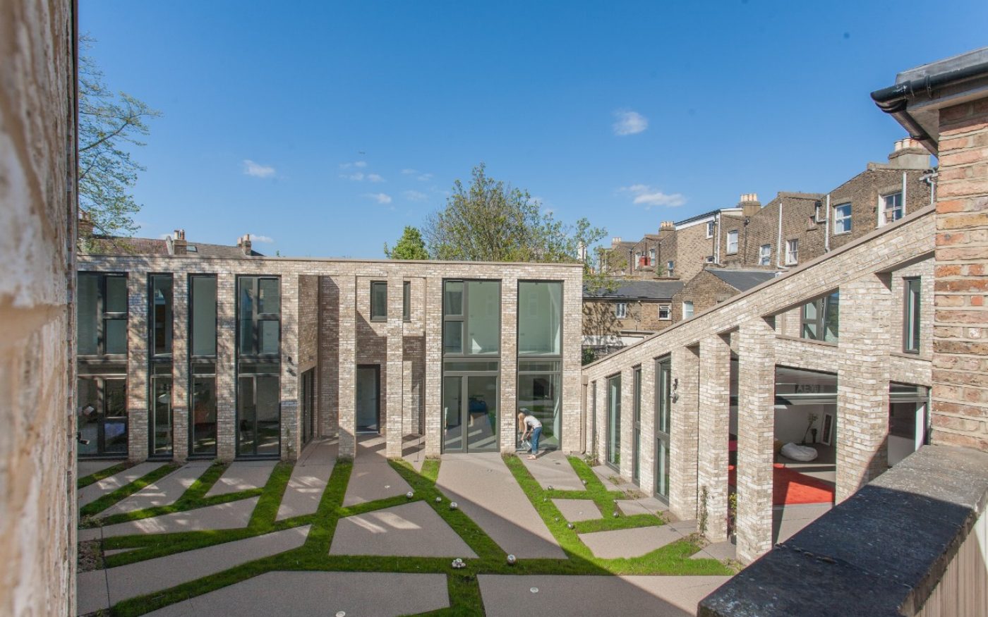 Asymmetrical large patio design with grass in between