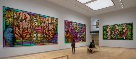 women and two children in the gallery looking at the colourful artwork