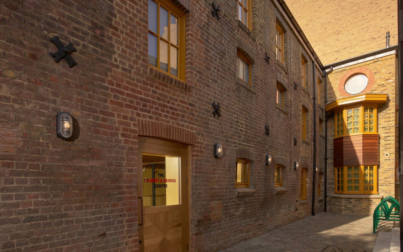 External facade of the brick used for the building showcasing the yellow window frames
