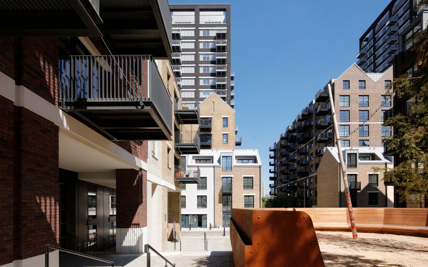 Several buildings in Goodluck Hope housing development with blue sky in background