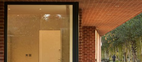 Close image of large window and red brickwork of the new building