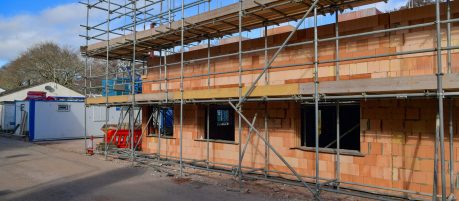 Exterior of apartment building in construction with scaffolding