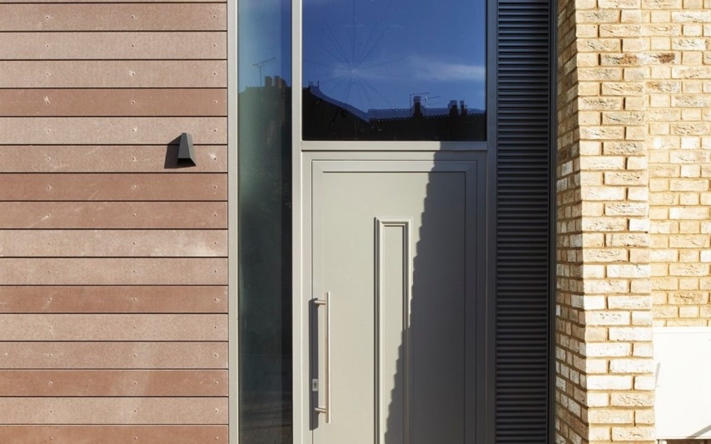 Pale modern front door of new Heath Lodge developement