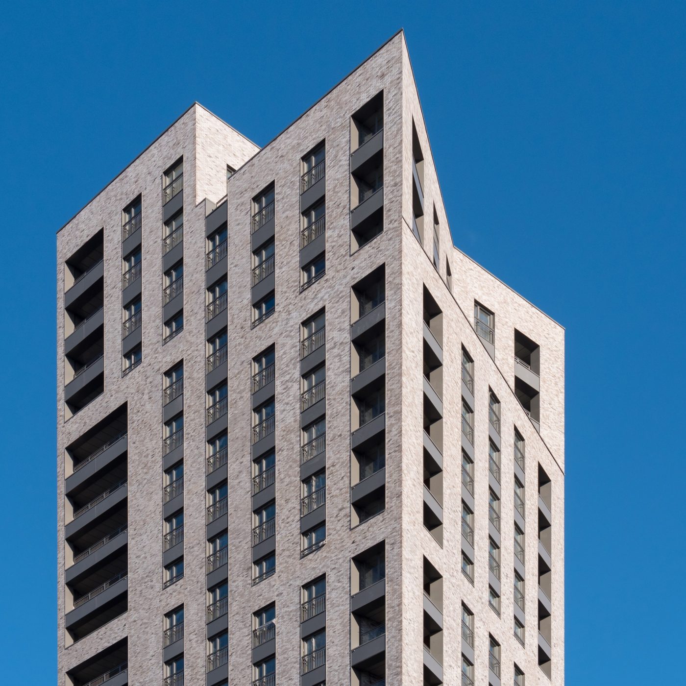 Exterior of modern apartment building against blue sky