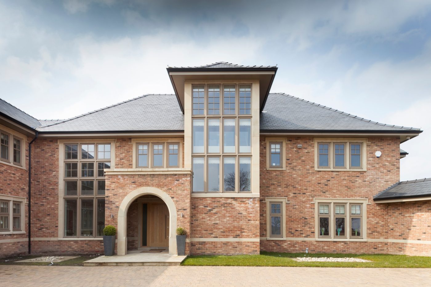 Large modern detached house with driveway and front lawn