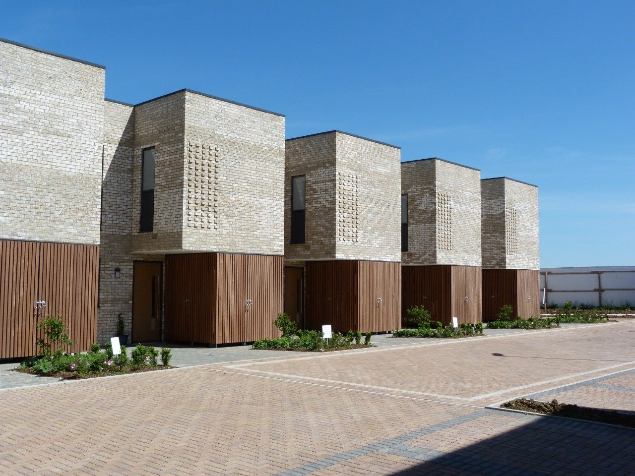 Modern brick terraced houses with wood cladding