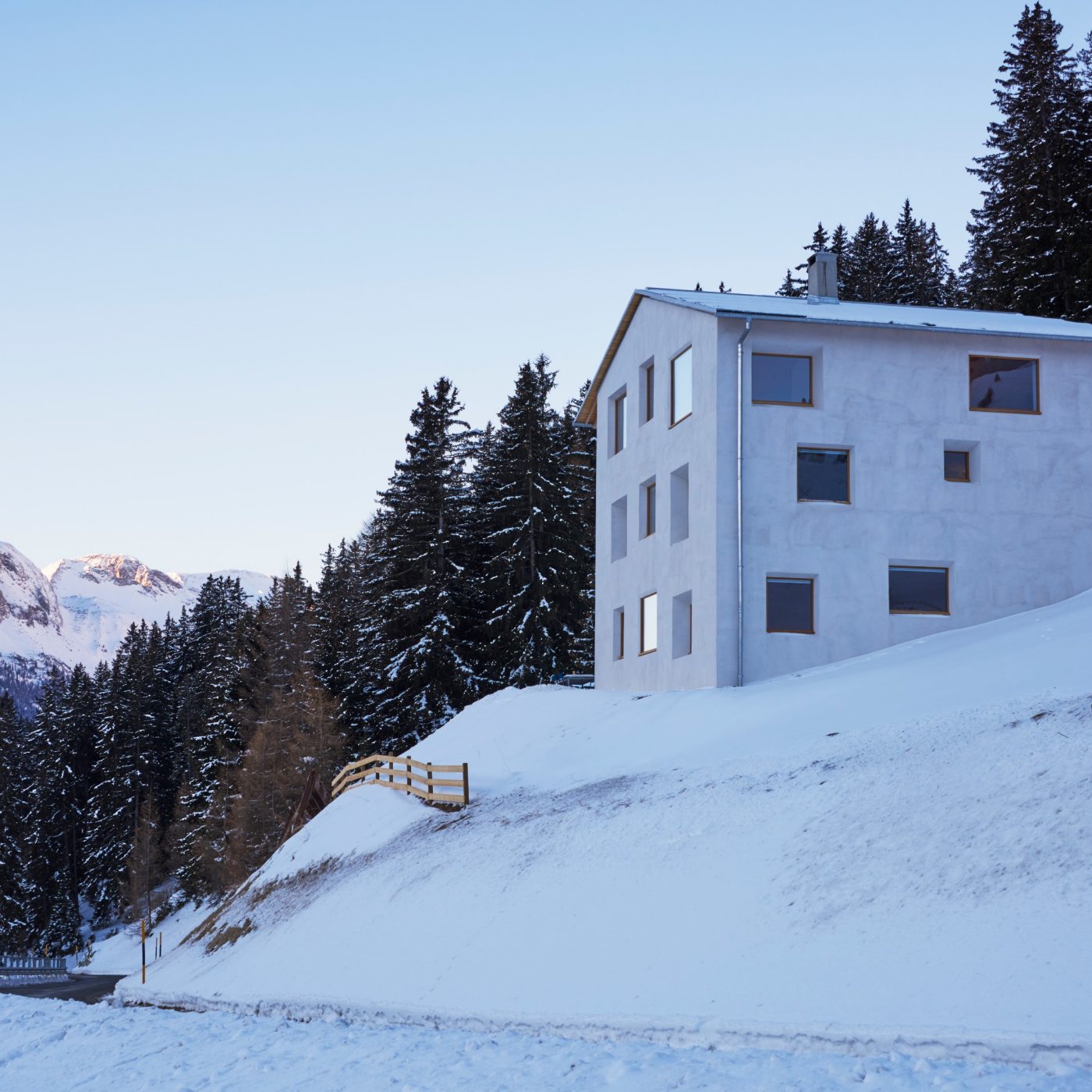 White modern chalet on snowy mountainside