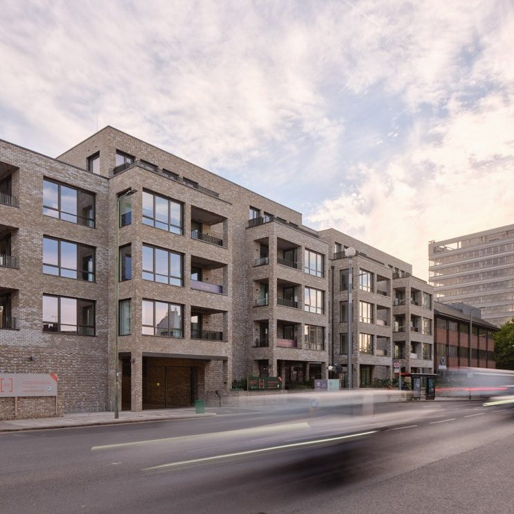 Large office building with busy road in front of it