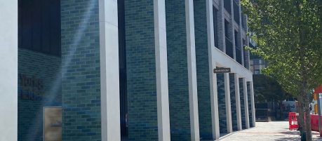 exterior of longley apartment block with blue and green glazed brick columns