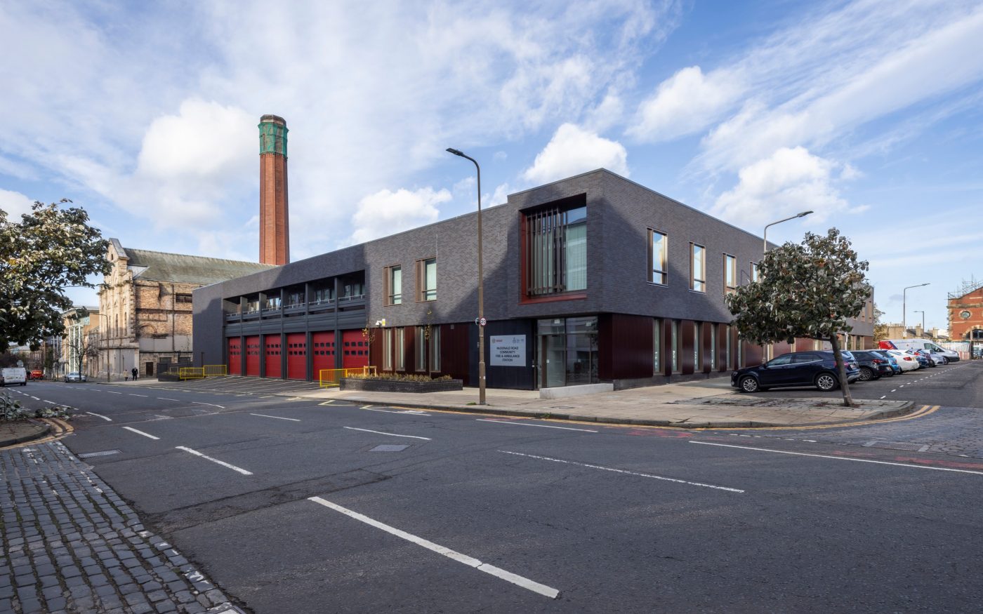 McDonald Road fire station exterior after renovation with tall chimney behind