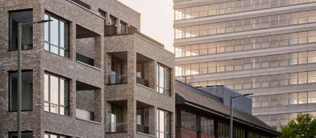 New build modern construction surrounded by large complexes and smaller developments
