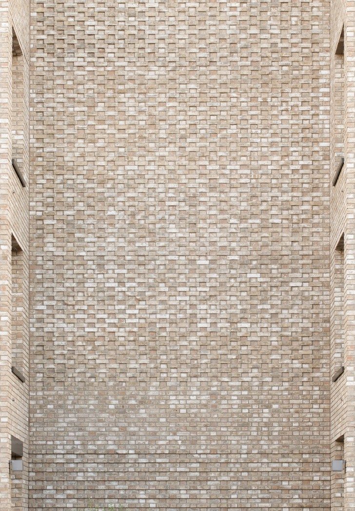 Modern buff brick used on new multi-storey building at dusk