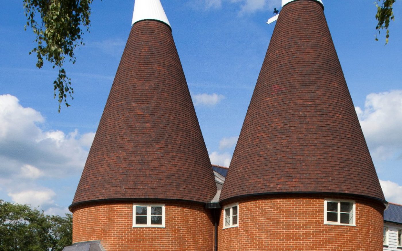 Oast houses with conical roof with red clay roof tiles