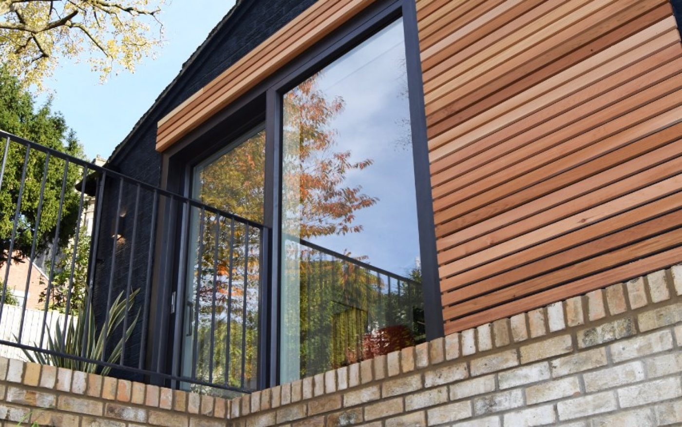 Modern wooden facade on brick building