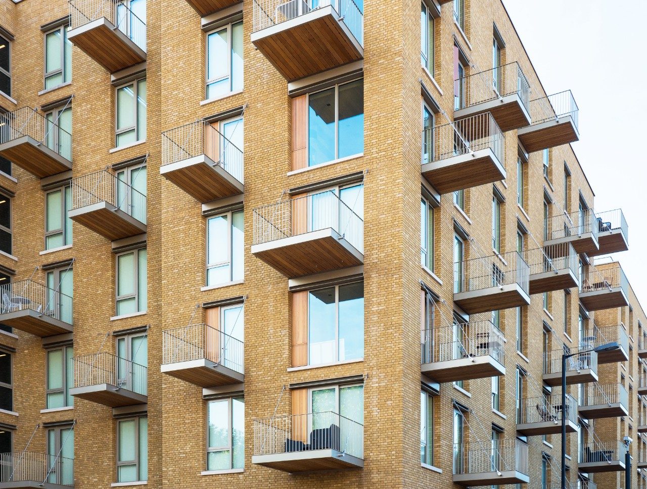 Balconies on modern residential yellow brick building