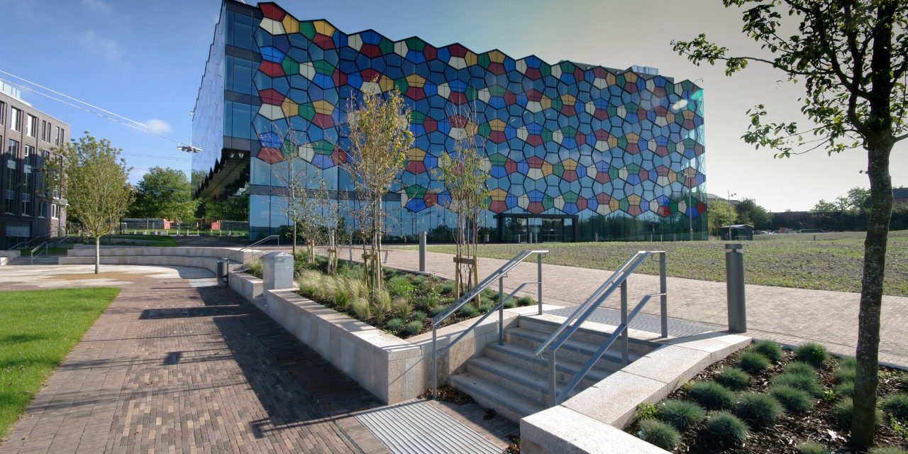 Business district in Stoke-on-Trent with modern glass building and paved outside area