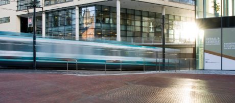 Train in motion travelling through the urban area