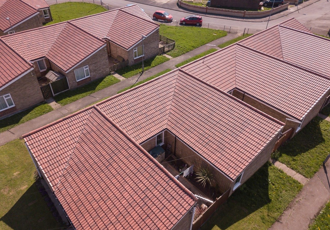 Social housing project with renovated red tiled roof