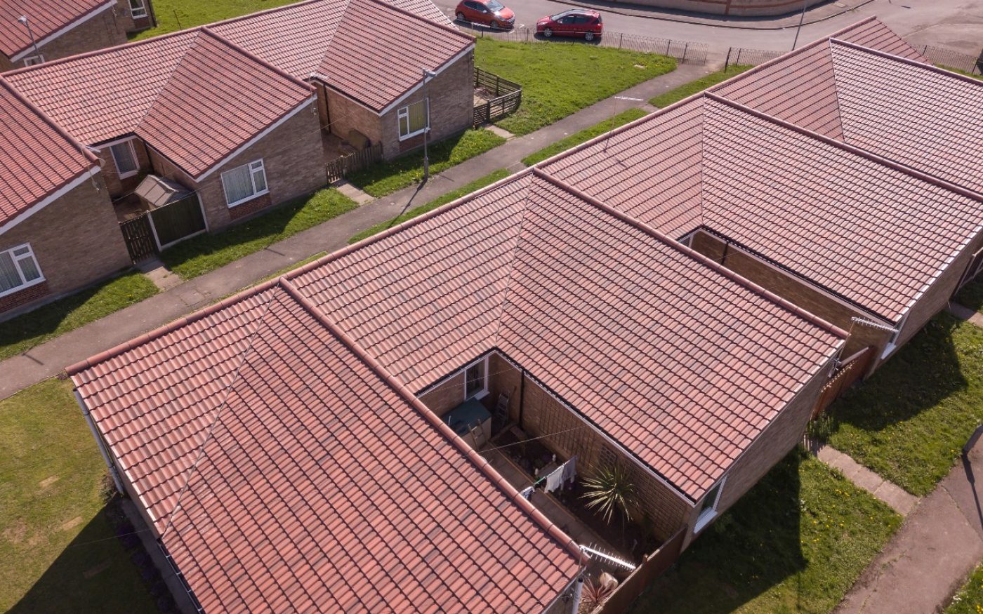 Renovated red roofs of social housing project called Priordale Road