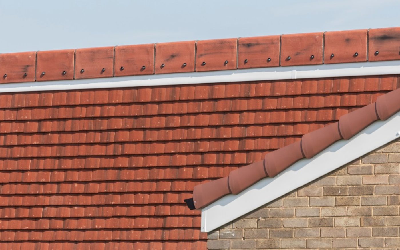 Red concrete roof tiles on roof renovation project