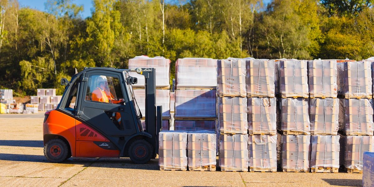 Forklift lifting brick pallets at Ewhurst