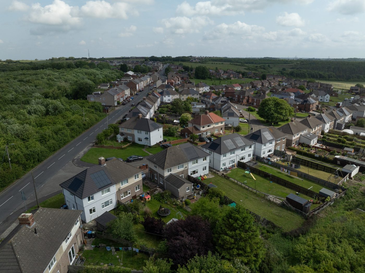 Aerial view of a residential neighbourhood surrounded by lush greenery.