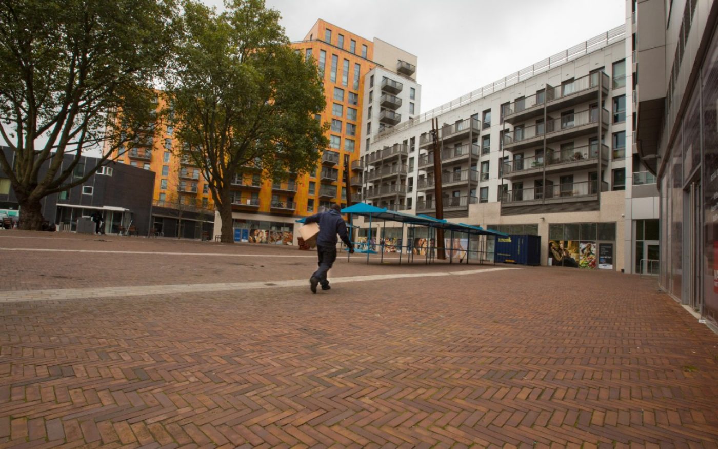 Man walking through paved walk way in Rathbone Market