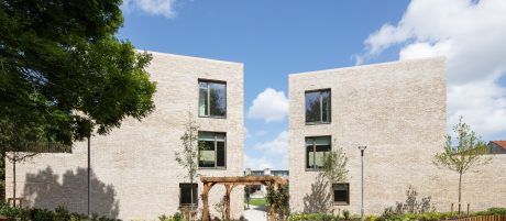 Multi-storey apartments with blue sky and lovely landscaped surroundings