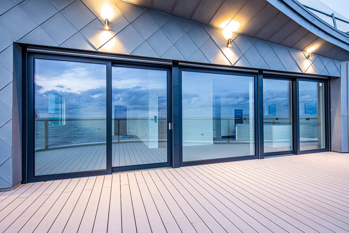 Large patio doors on modern balcony of apartment building