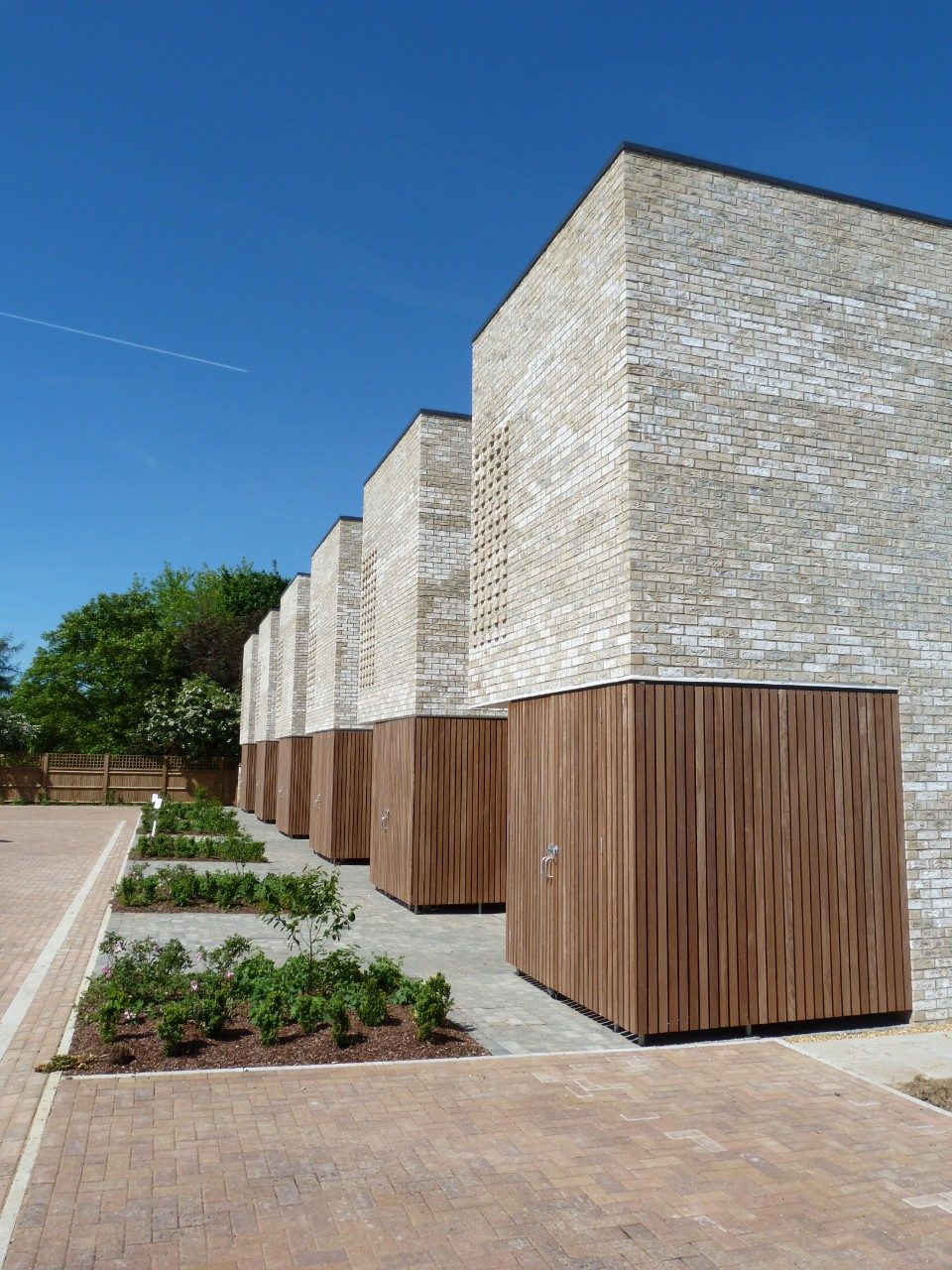 Modern buff brick residential buildings with grass areas at the front