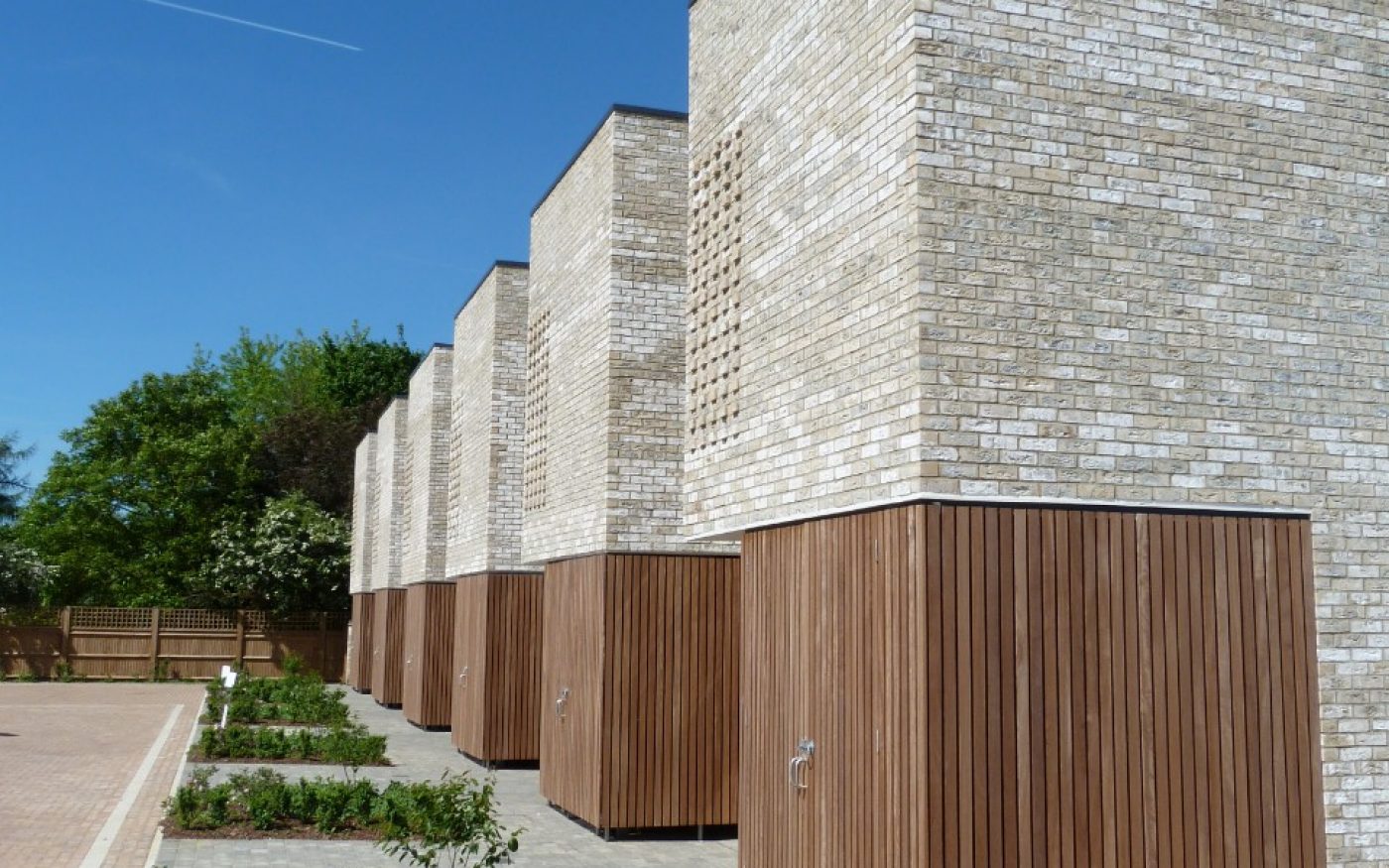 Modern brick terraced houses with landscaped area outside