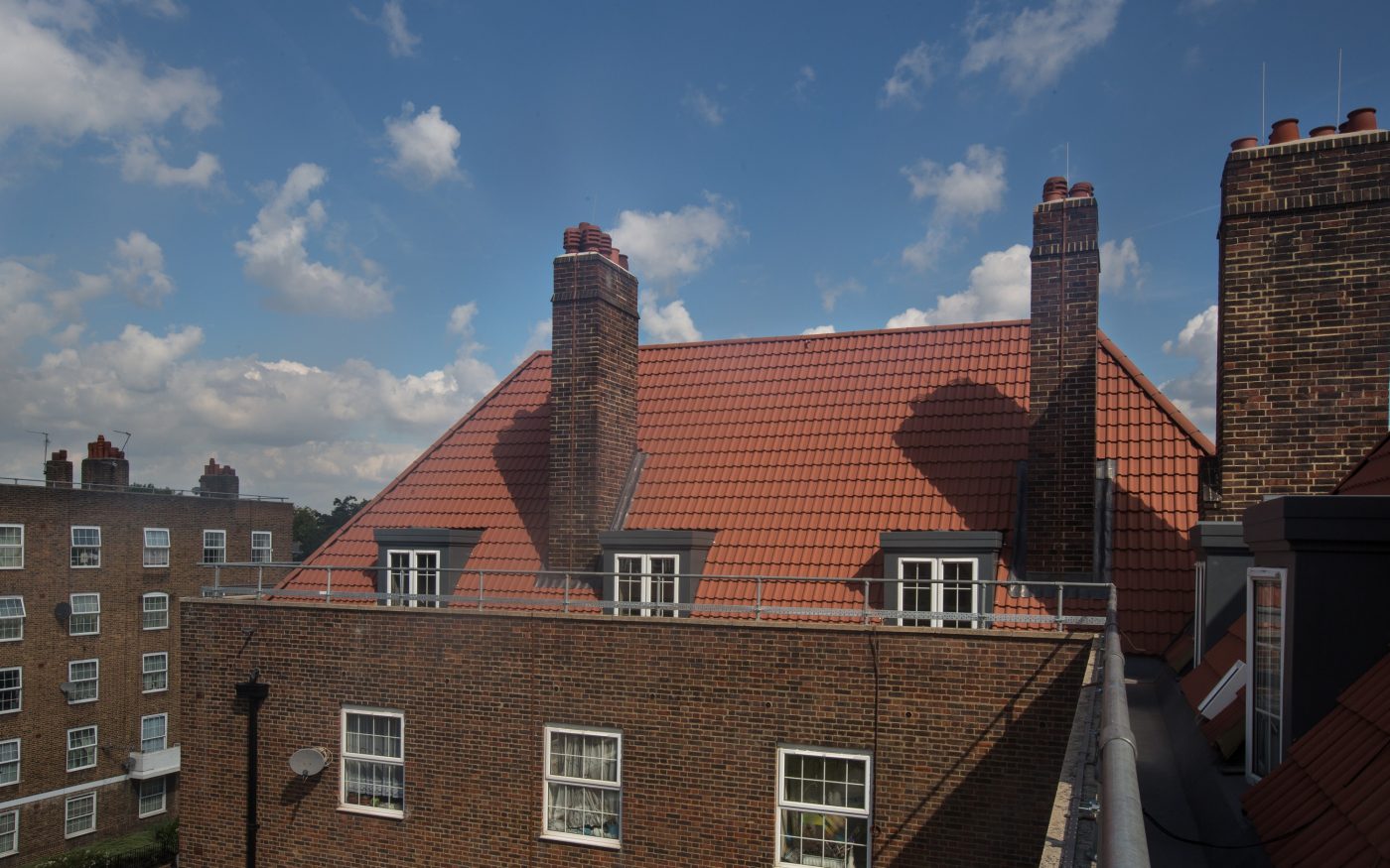 Red concrete roof tiles used on social housing in North London