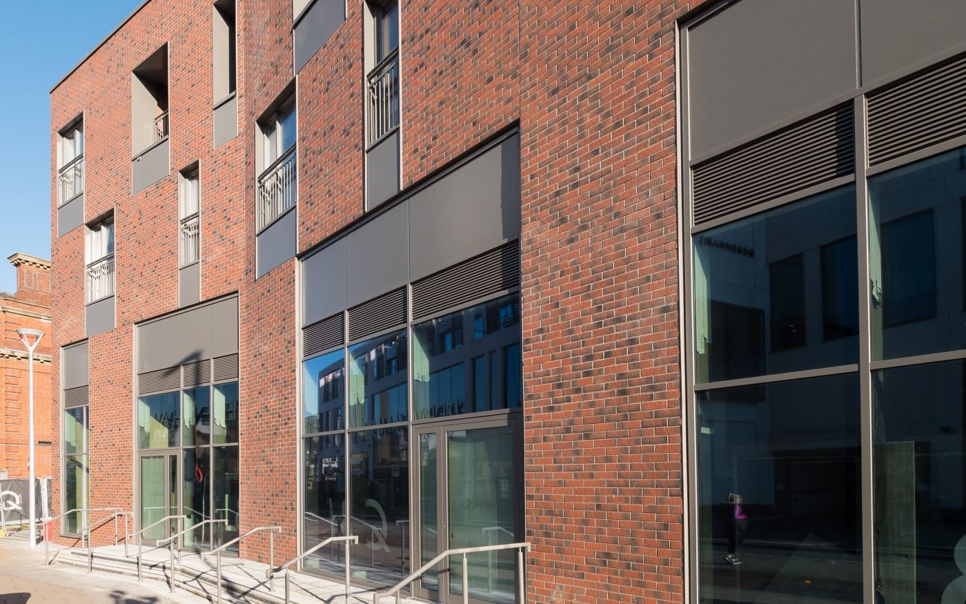 Modern brick building using red corium facade