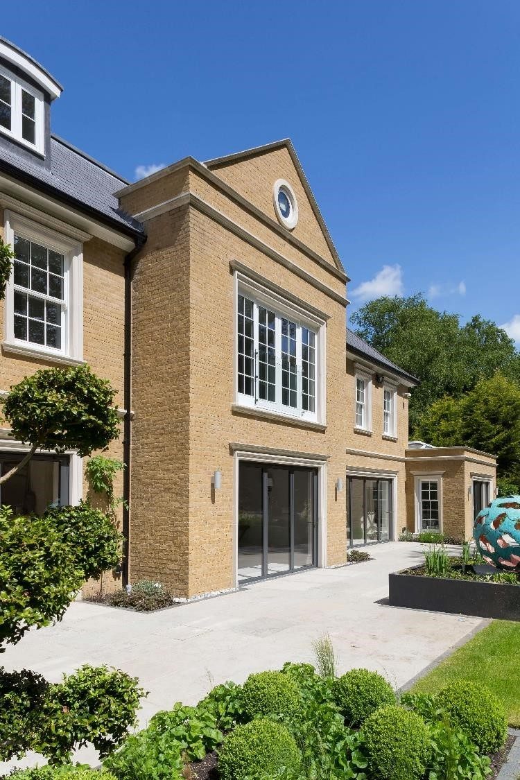 Traditional style large house with yellow Smeed Dean brick walls