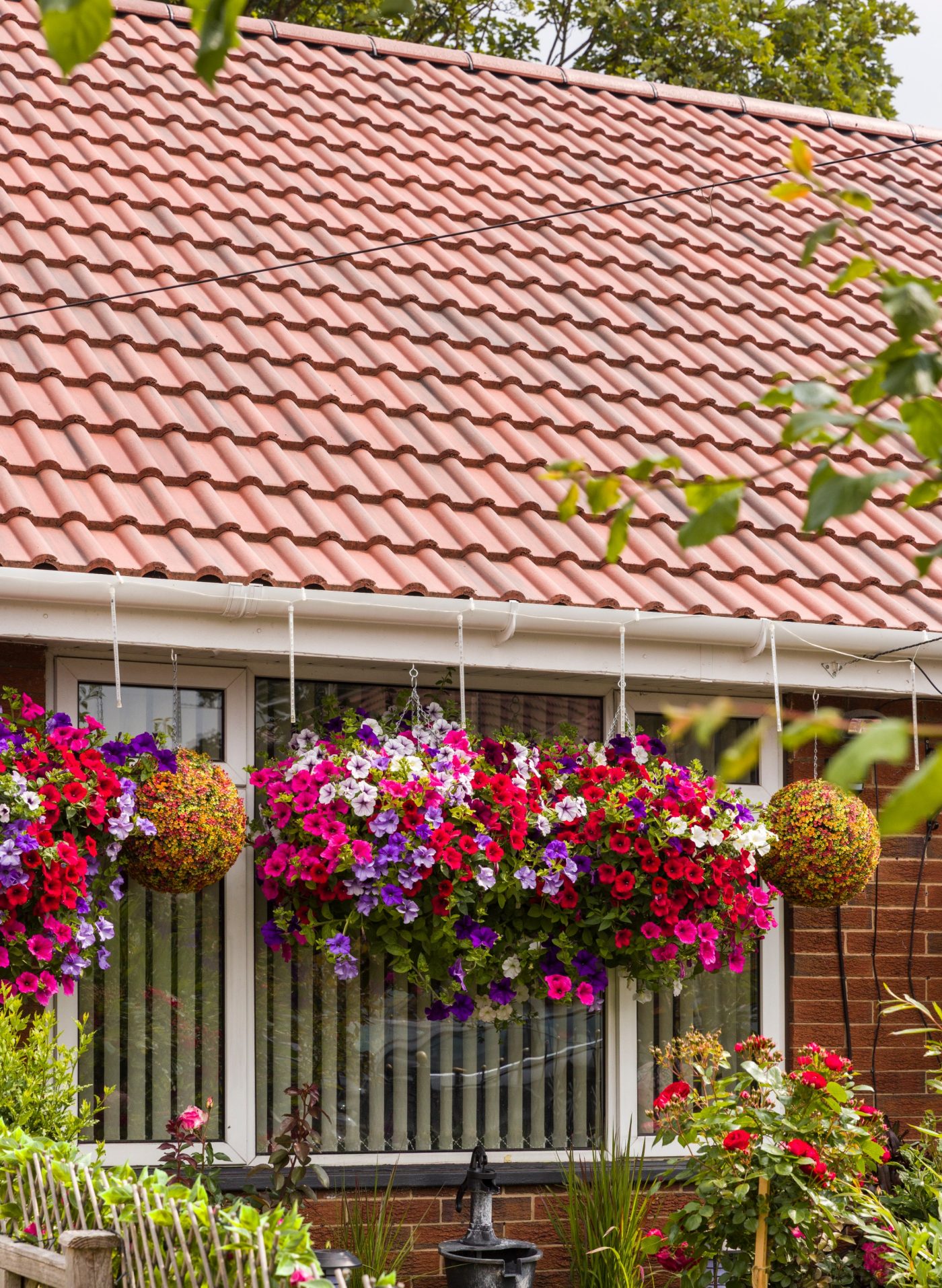 Aerial view of a residential neighbourhood surrounded by lush greenery.