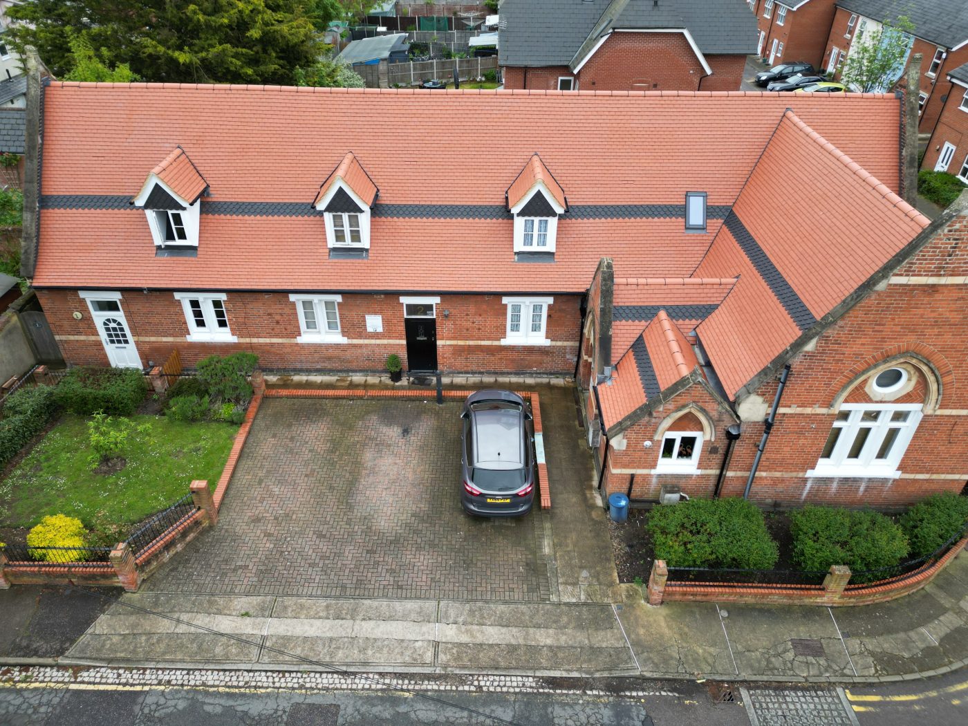 Birds-eye view of the newly renovated red clay tile roof on old school