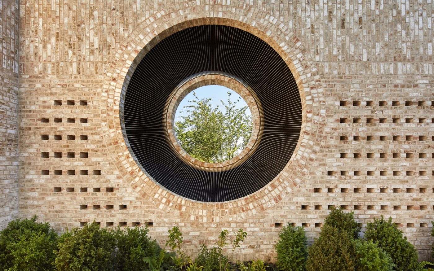 Big circular porthole window on external wall using Wienerberger's Con Mosso brick