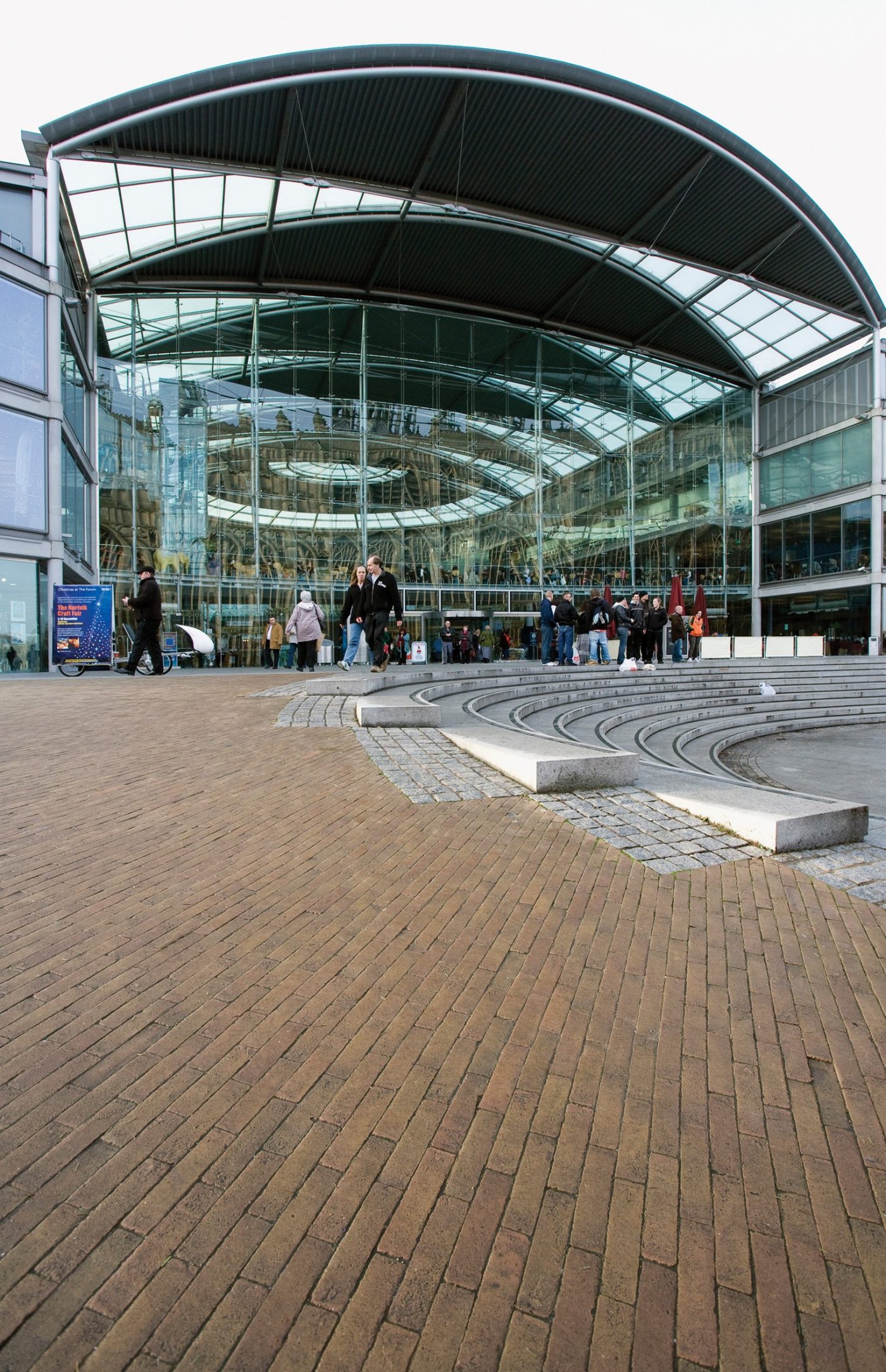 Millennium Plain modern building with paved area and pedestrians