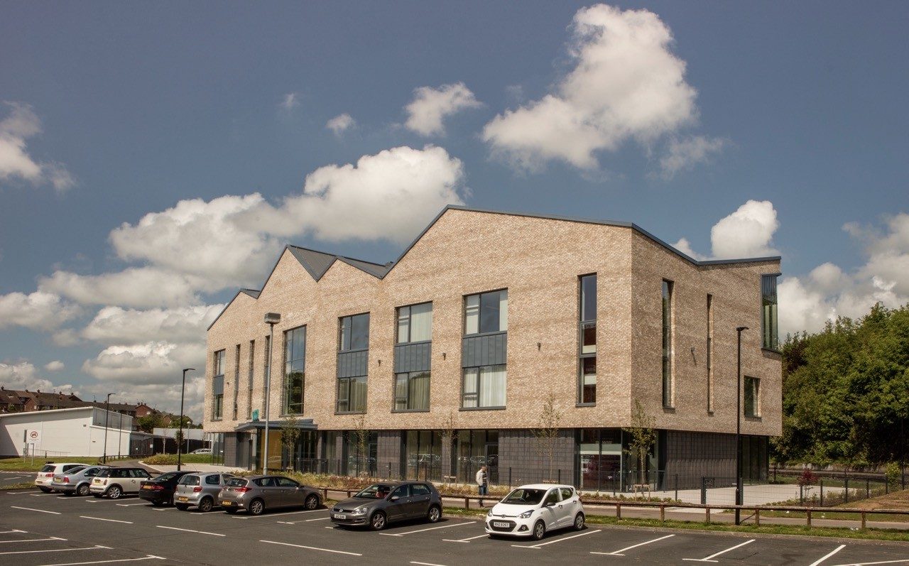 car park outside the junction dungannon building with blue sky