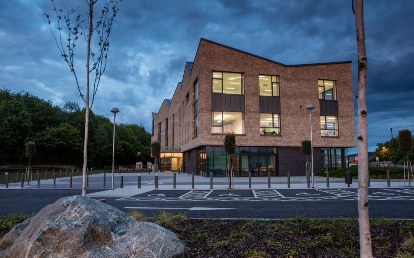The Junction modern brick building at night