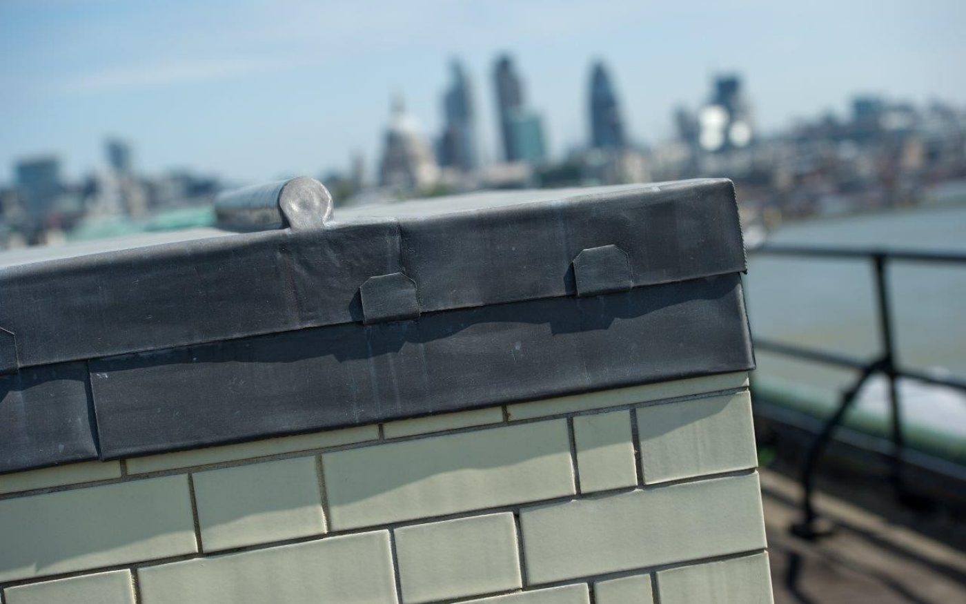 Close up of the white brick with the London skyline in the background