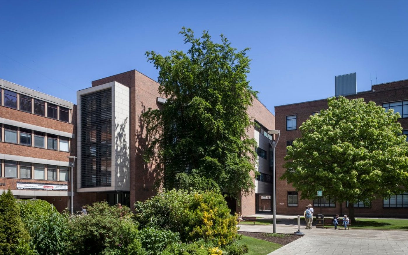 Exterior of the new red brick development with trees and greenery outside