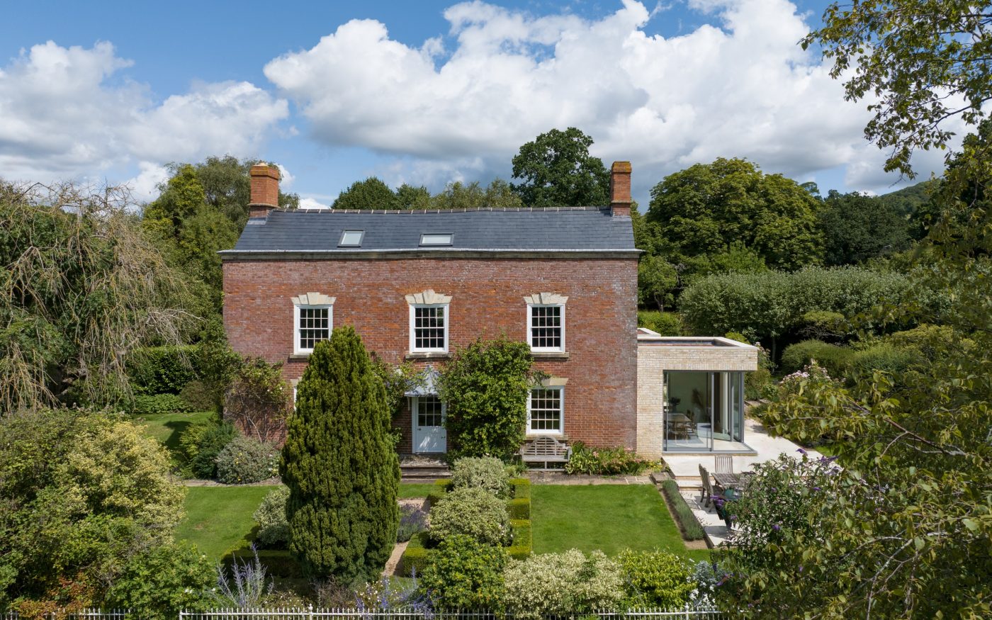 Georgian farmhouse with Marziale brick extension on the right side of the building