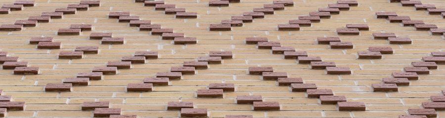 close up of protruding red Corium brick tiles and buff Corium brick tiles in a pattern