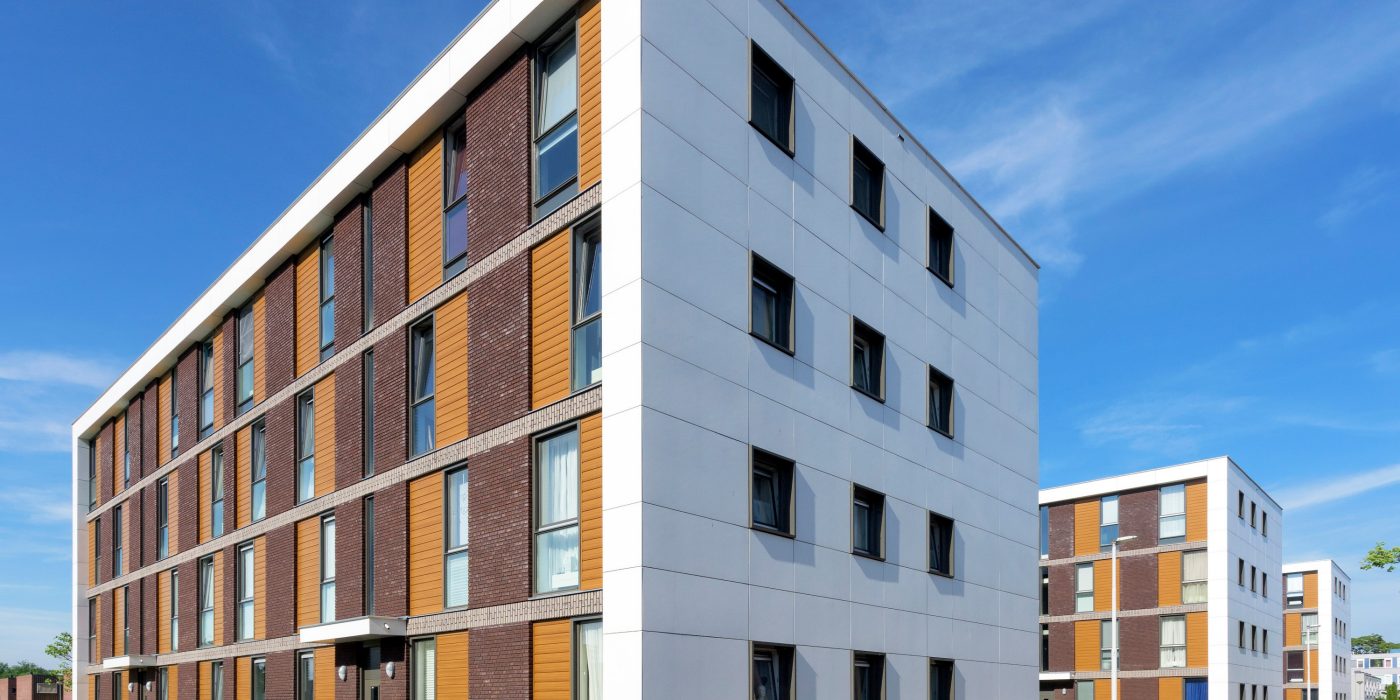 Exterior of modern apartment block with blue sky