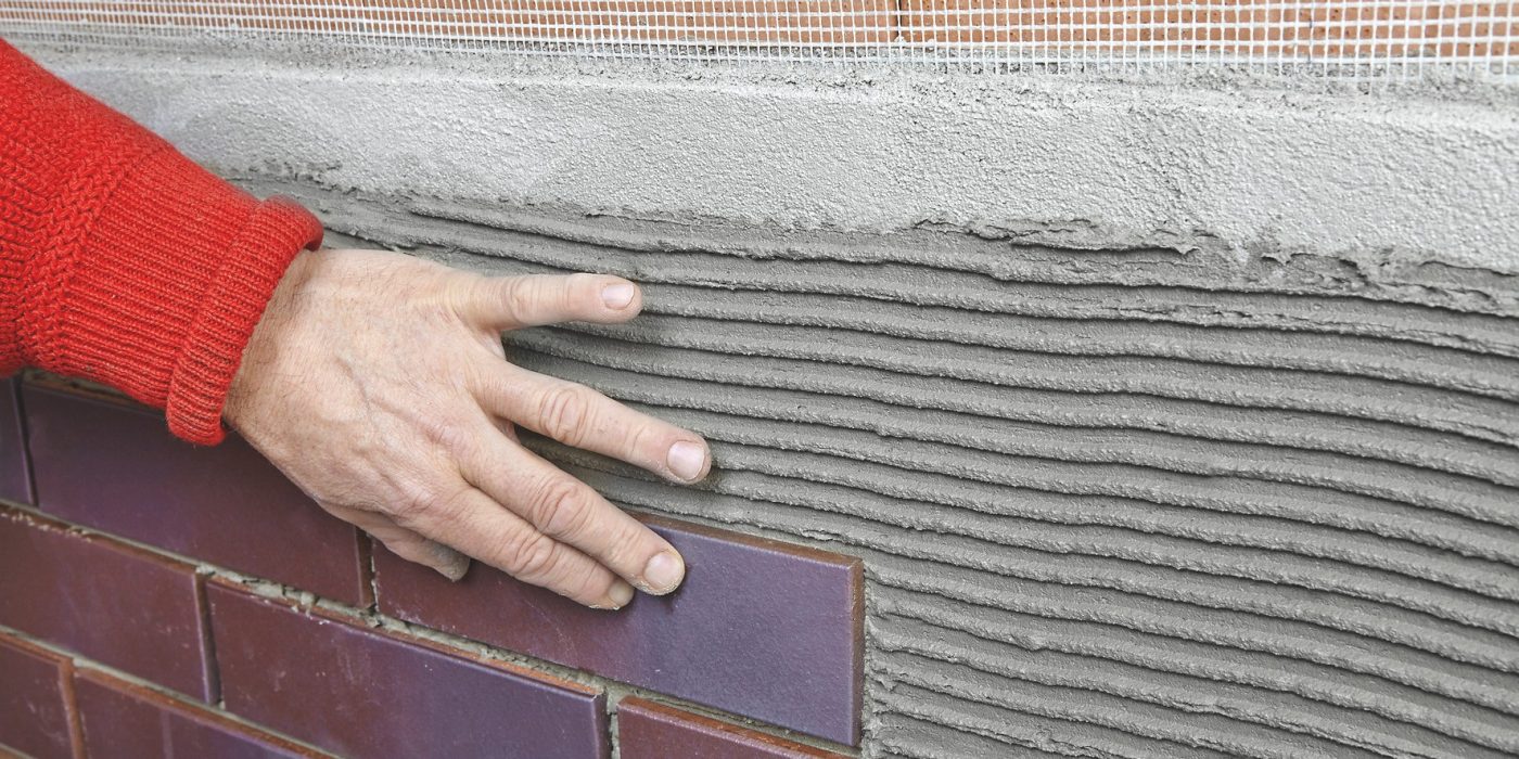 Man applying brick slips