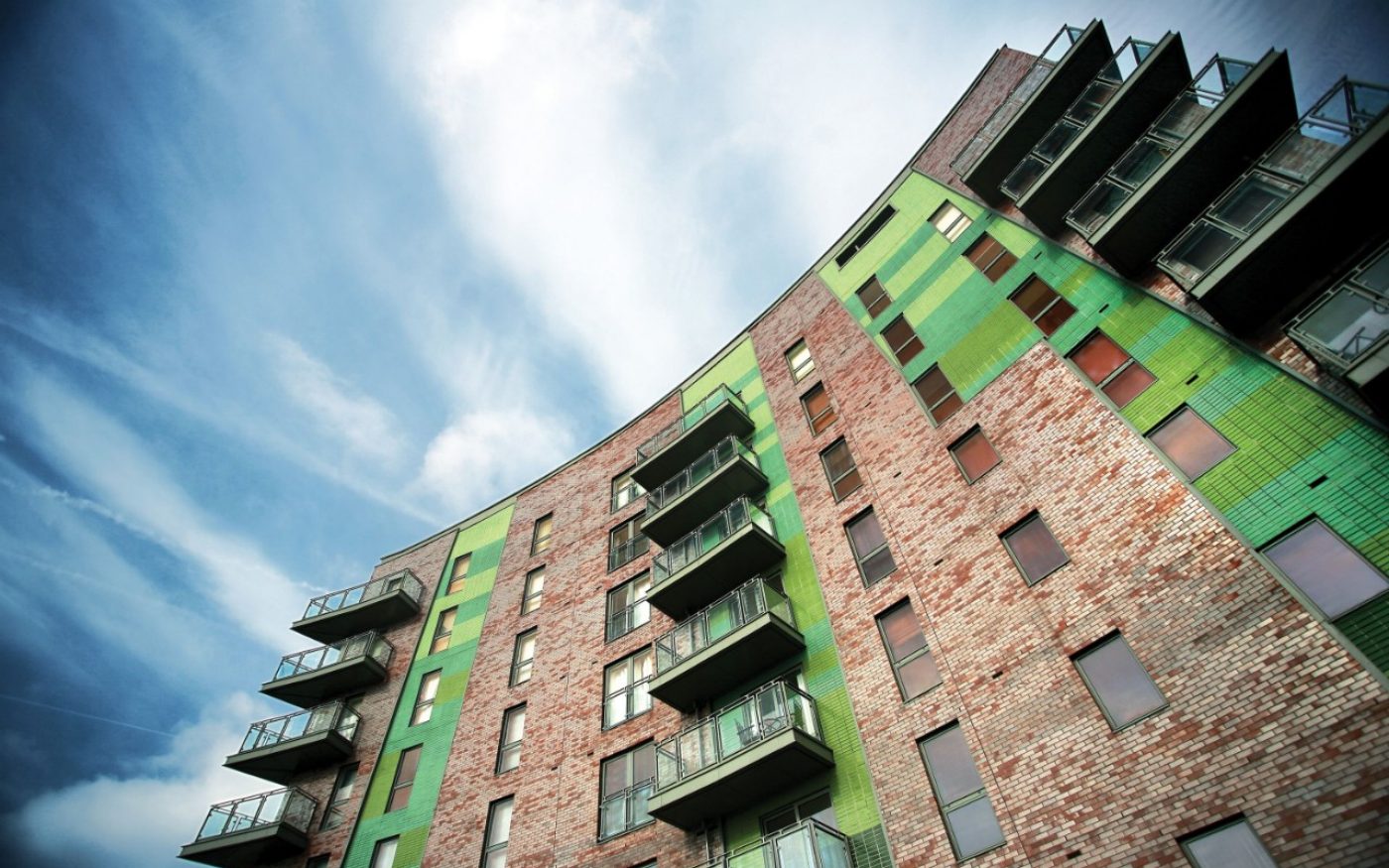 Looking up at building with green Corium brick tiles