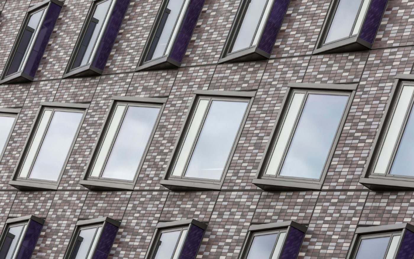 Close up of Corium brick tiles in various colours alongside windows