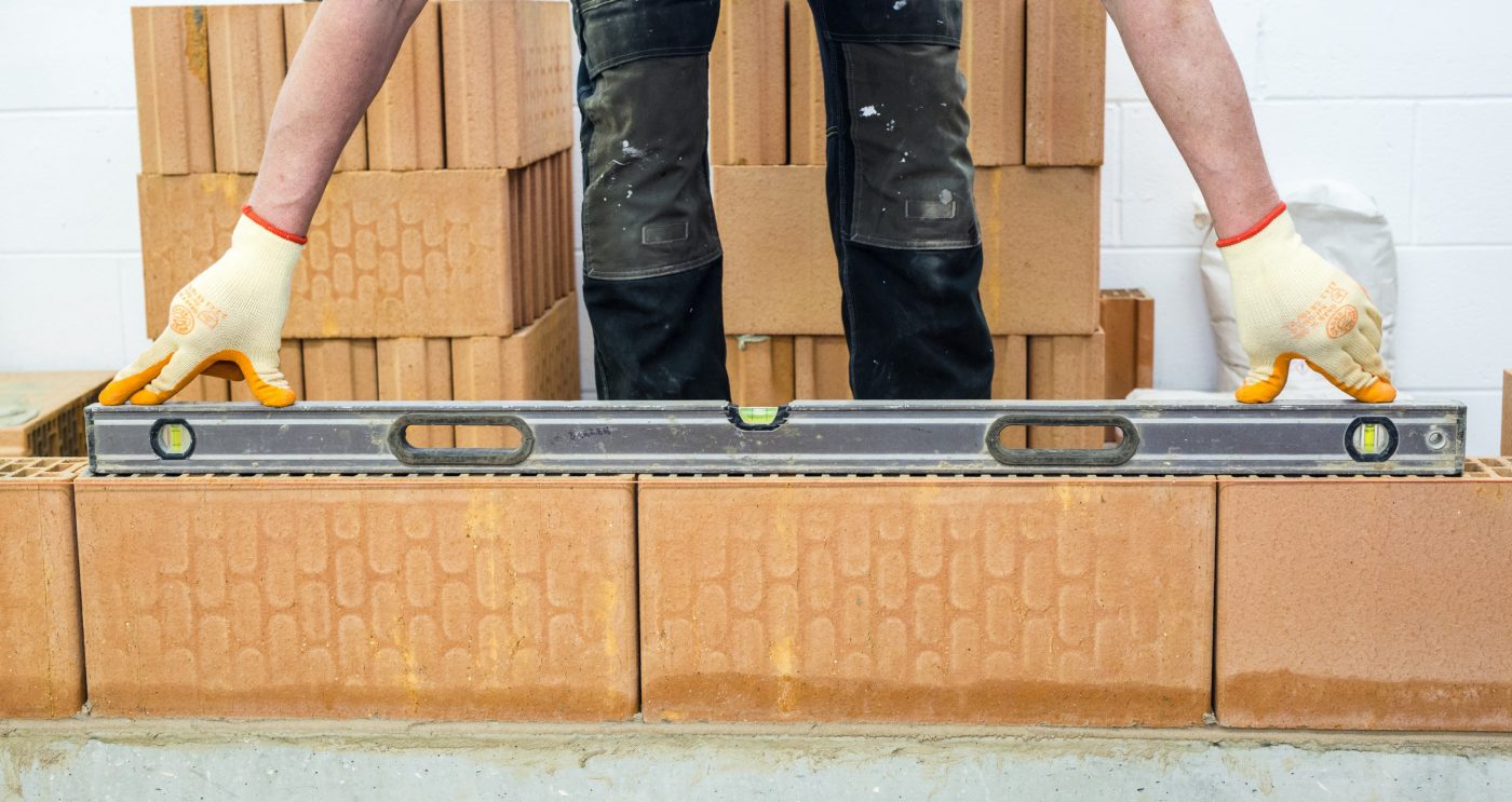 Man laying clay blocks